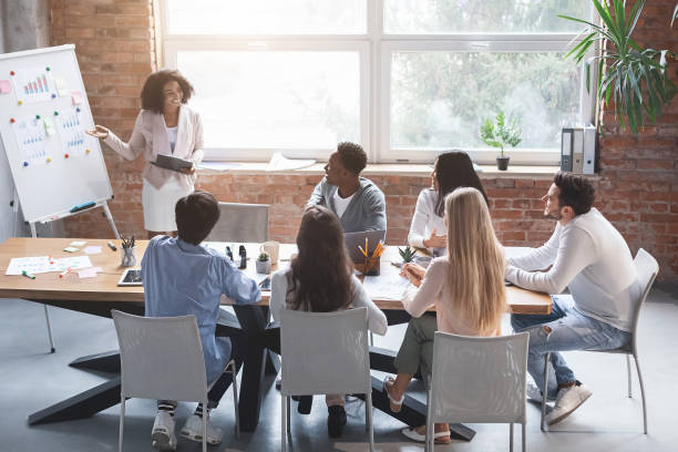 istock Black employee making presentation during morning briefing 1205975653