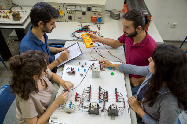 piccolo gruppo di studenti in laboratorio di ingegneria elettrica - circuit board electrical equipment engineering technology foto e immagini stock