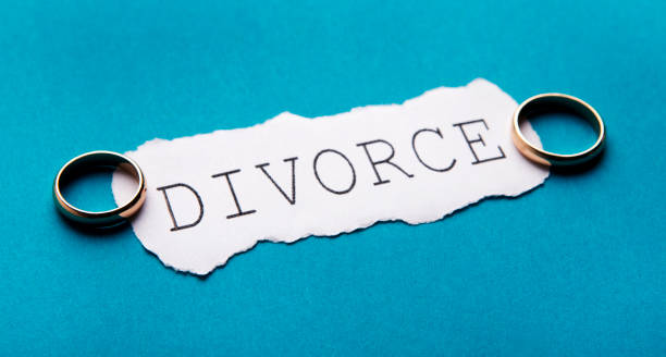 istock Letters divorce and wedding rings on blue background 1205977143