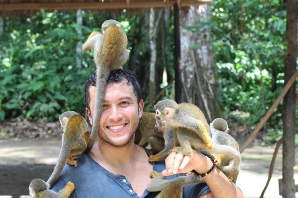 istock Man and Titi monkeys in the Amazon region 1205977198