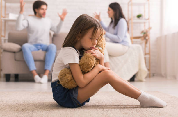 upset little girl cuddling teddy bear, suffering from parents arguing - surprise child little girls shock imagens e fotografias de stock