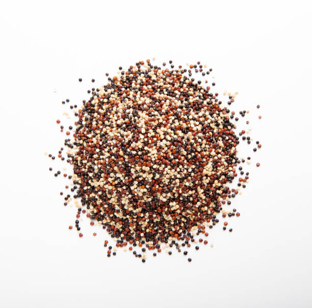 istock Mixture of red, black and white quinoa seeds isolated 1205977549