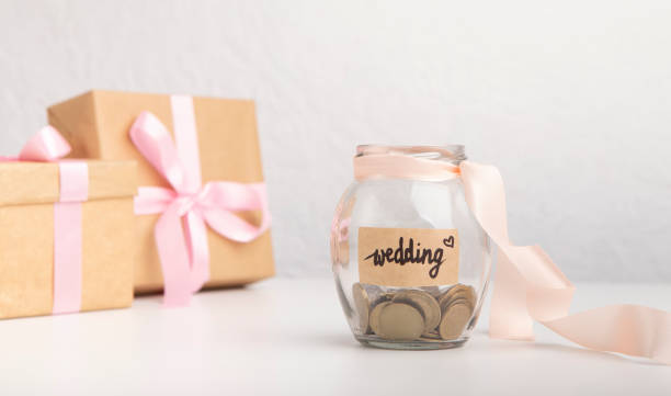 cash money coins in glass jar with text written for wedding - coin cheap jar currency imagens e fotografias de stock