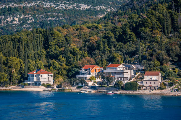 istock Panoramic landscape of mediterranean town on a sandy seacoast, deep blue sea on foreground 1205978369