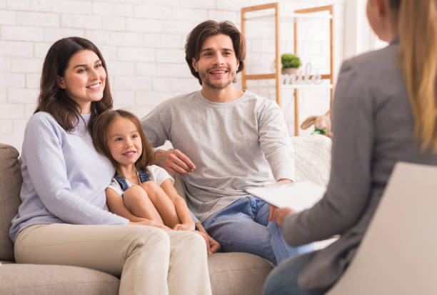 Parents With Little Daughter Sitting At Psycholigist's Office After Successful Therapy Happy Parents With Little Daughter Sitting Together At Psycholigist's Office After Successful Family Therapy alternative therapy stock pictures, royalty-free photos & images