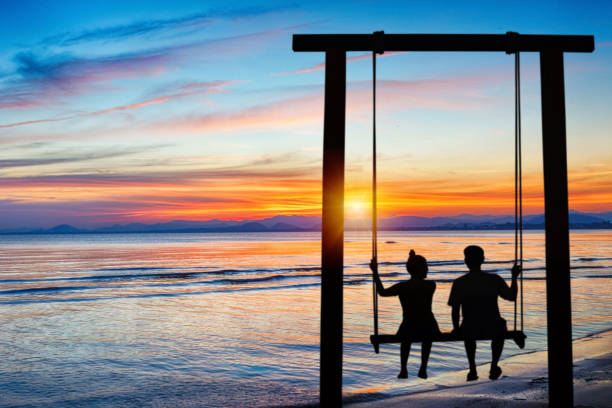 istock Couple at beach on twilight time 1205979912