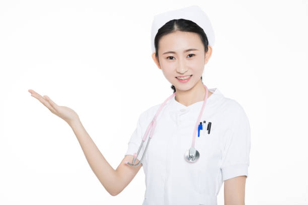 istock beautiful young female nurse, white background. 1205980384