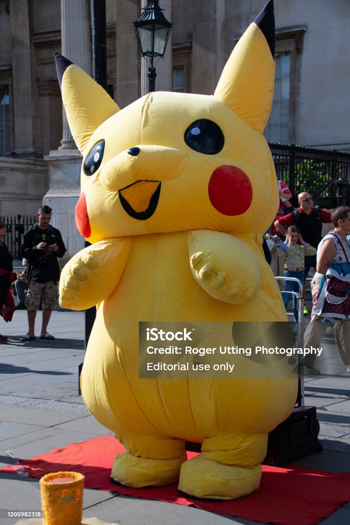 A Person Dressed In An Inflatable Pikachu Costume To Entertain Pokemon Fans  Outside The National Gallery In Trafalgar Square Stock Photo - Download  Image Now - iStock