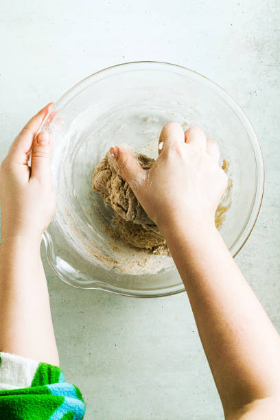 istock mixing dough for chocolate cake in a bowl. female hands and a kitchen whisk. recipe step by step 1205982666