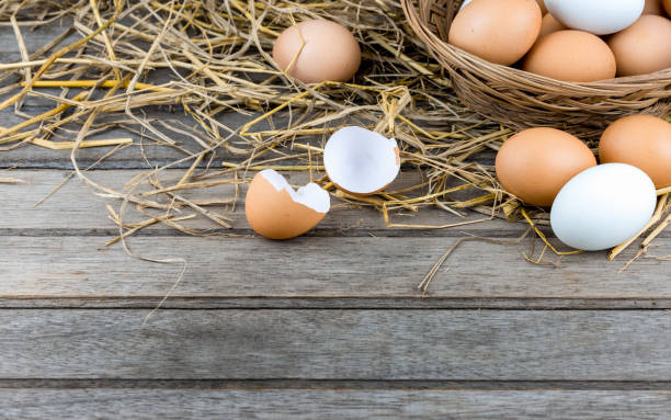 istock Stack of egg in basket on straw with wooden table background.Free space. 1205982705