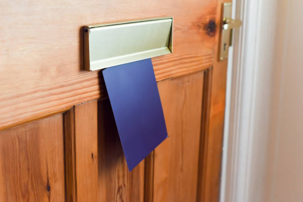 istock Blank leaflet or flyer being posted through a letter box unwanted junk mail 1205982708