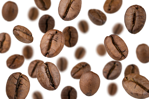 Roasted coffee beans in a 1/2 cup measure to prepare a correct amount of expresso coffee.