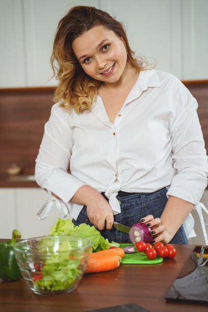 istock Pretty young woman looking straight at camera 1205983342