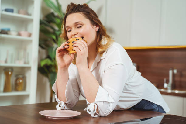 istock Positive delighted plump girl having unhealthy dinner 1205983385