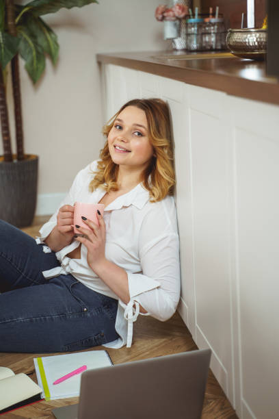 istock Kind curly haired female having break for tea 1205983483