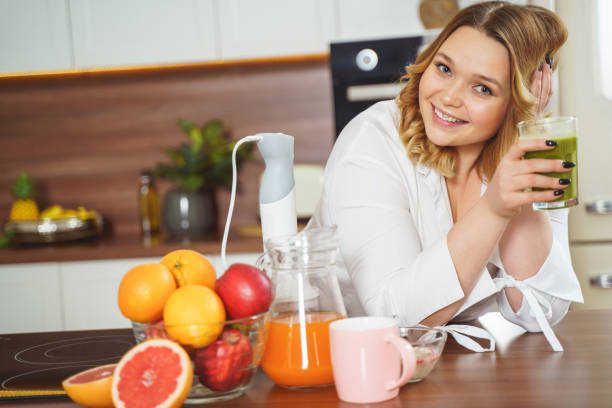 istock Positive delighted female person looking straight at camera 1205984234