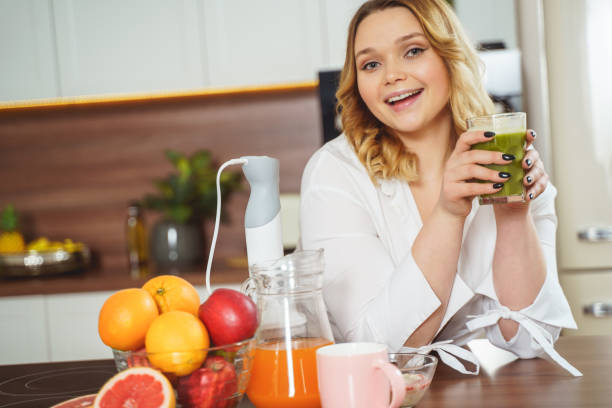 istock Cheerful young woman spending her morning in the kitchen 1205984237