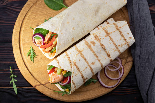 istock Mexican burrito with chicken, pepper and beans. Top view 1205985826