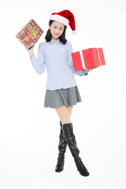 istock girl wear christmas hats, studio shot. 1205987733