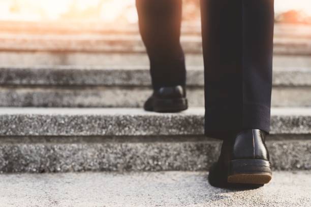 istock Image of a man walking up the stairs.concept successful. 1205988682