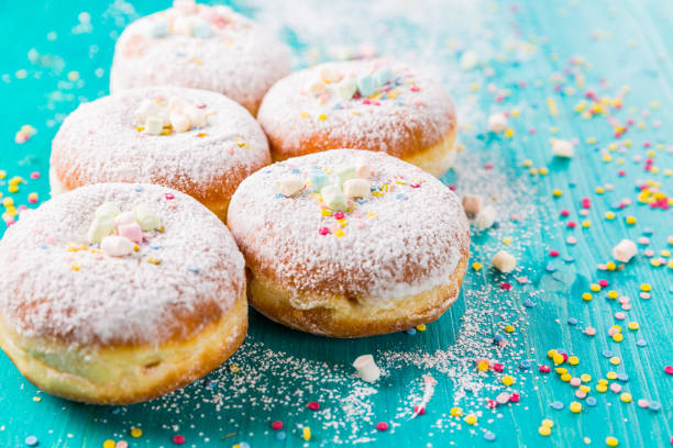 istock Carnival powdered sugar raised donuts - German Berliner donuts, Krapfen filled with jam 1205991958