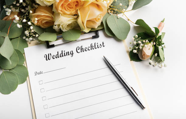 istock Checklist with pen for writing and cream roses 1205992644