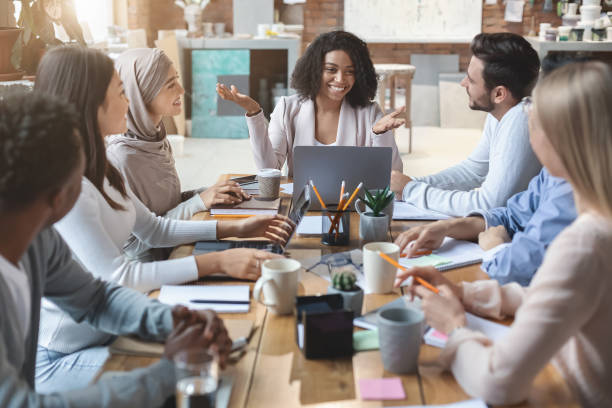 istock Cheerful young business group having morning briefing in office 1205993304