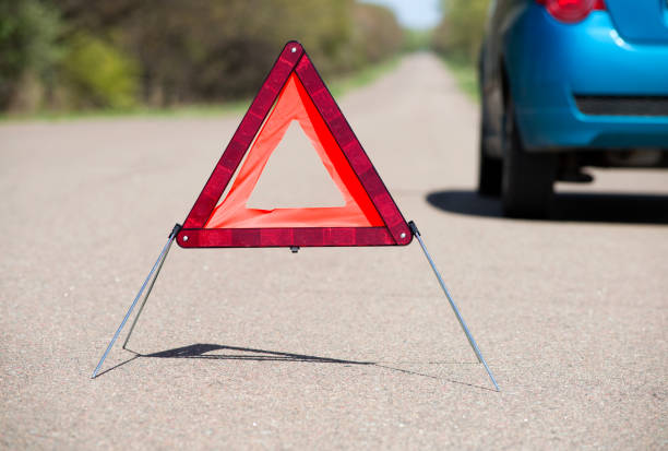 istock A breakage triangle on the road in front of car 1205993512