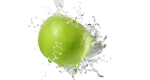 istock Apples in splash of water isolated on white background 1205994168