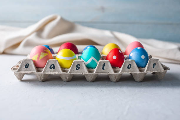 istock Colorful decorated bright Easter eggs in a tray on a wooden background. Festive spring card 1205996457