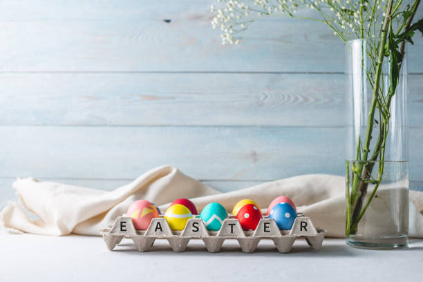 istock Colorful decorated bright Easter eggs in a tray on a wooden background. Festive spring card 1205996486