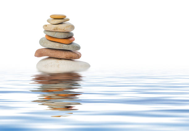 Stack of stones in water Stack of stones in water isolated on white background cairns photos stock pictures, royalty-free photos & images