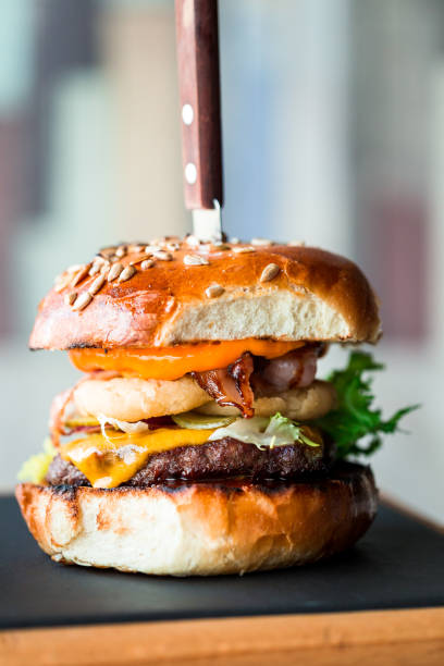 istock Fresh flame grilled bacon cheeseburger on wooden board 1205997375