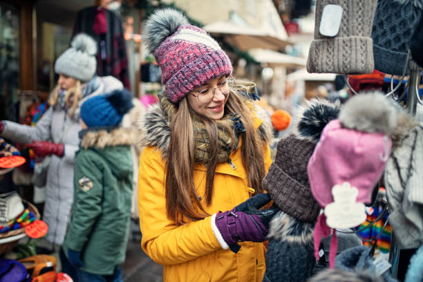 istock Family browsing winter caps in small alpine town 1205998256
