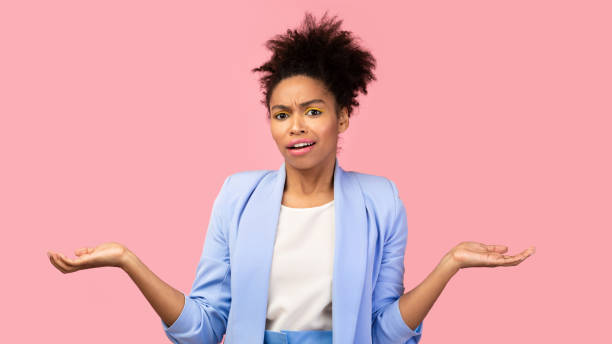 istock Clueless and confused black woman shrugging at studio 1205999352