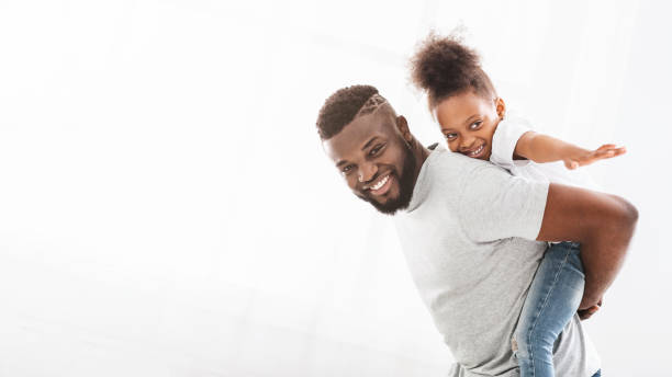 istock Happy black father holding his little daughter on his back 1205999412