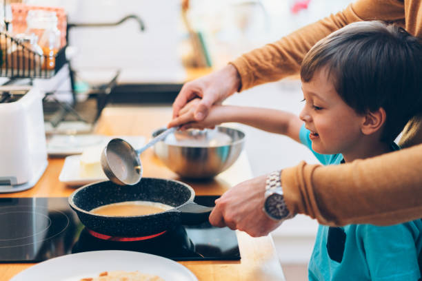 istock Single father with son cooking pancakes at home 1205999730