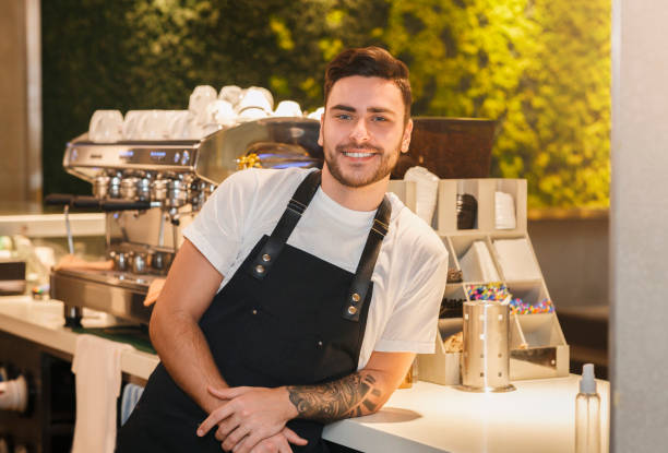 istock Barista Guy Posing Near Coffee-Machine Standing In Cafe 1206000020