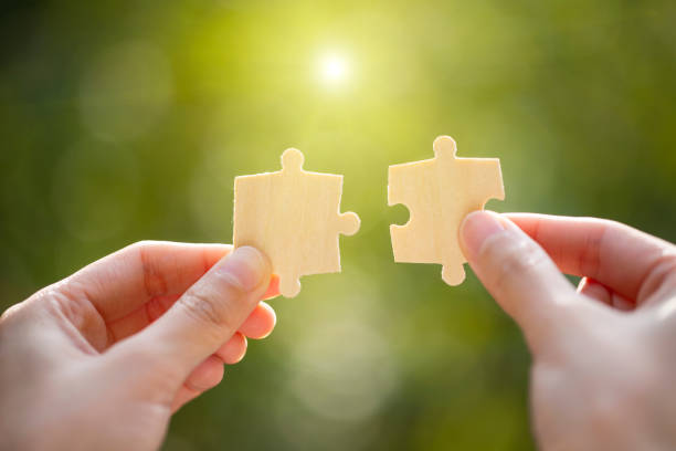 istock Hand holding jigsaws. Connection concept. 1206002167