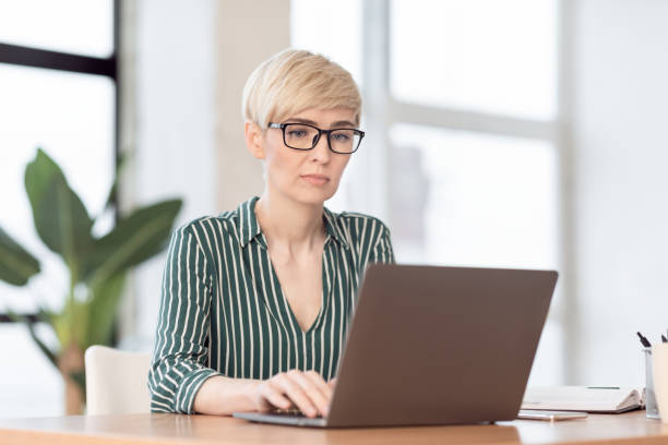 istock Serious Businesswoman Using Laptop Working In Modern Office 1206002241