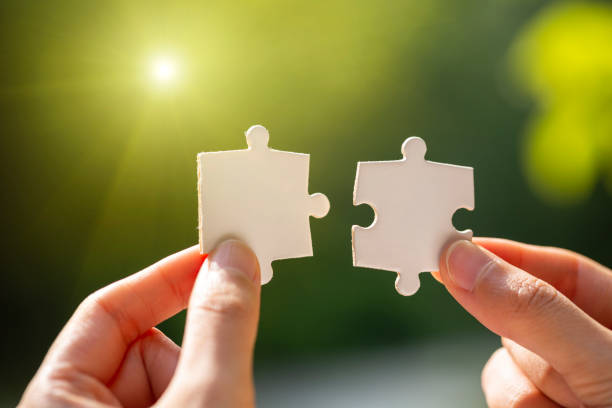 istock Hand holding jigsaws. Connection concept. 1206002254