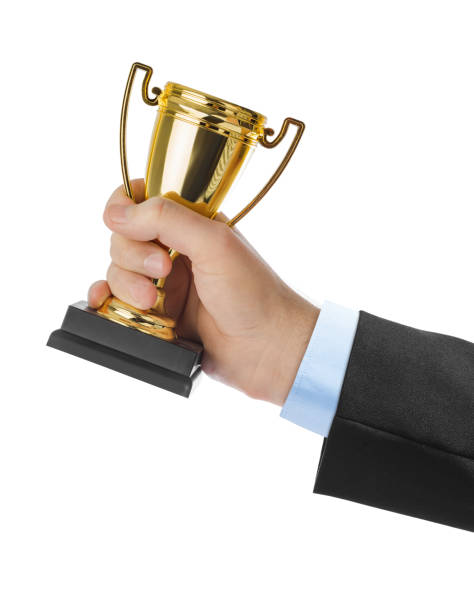 istock Golden trophy cup in hand 1206003613