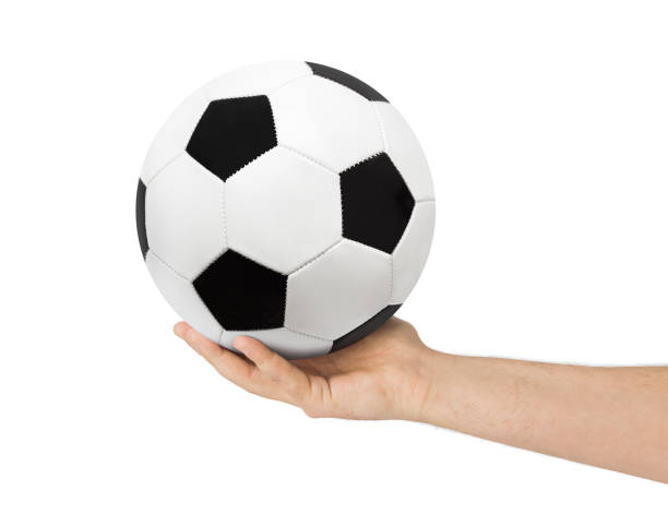 istock Hand and soccer ball 1206003821