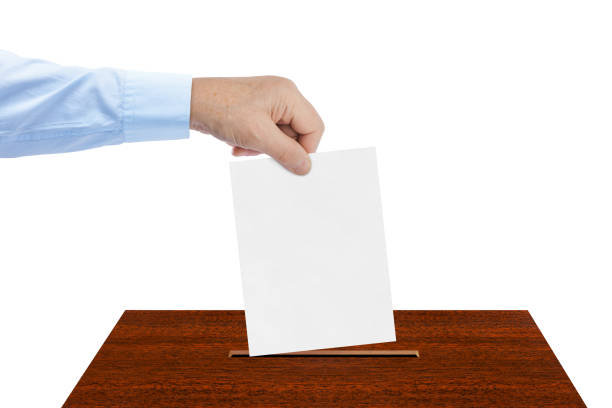 istock Hand with paper ballot 1206003974