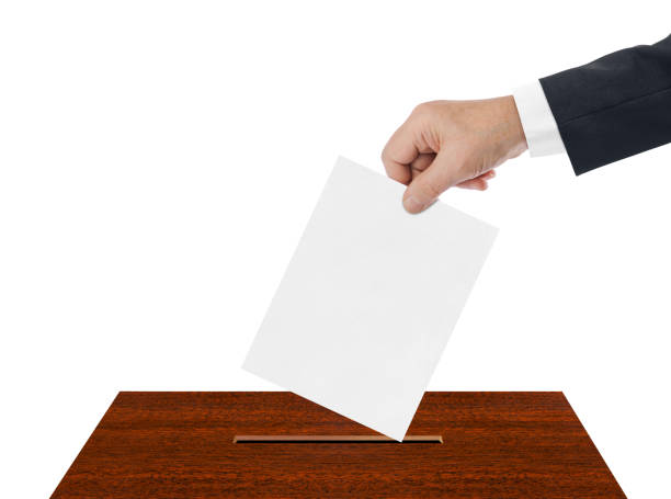 istock Hand with paper ballot 1206003999