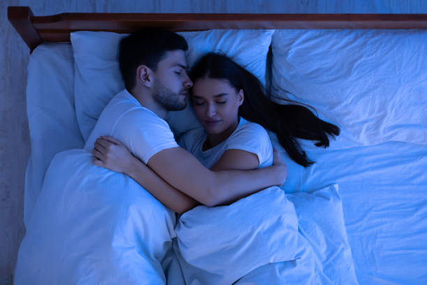 istock Loving Couple Hugging Sleeping In Bed At Home, Above View 1206004101