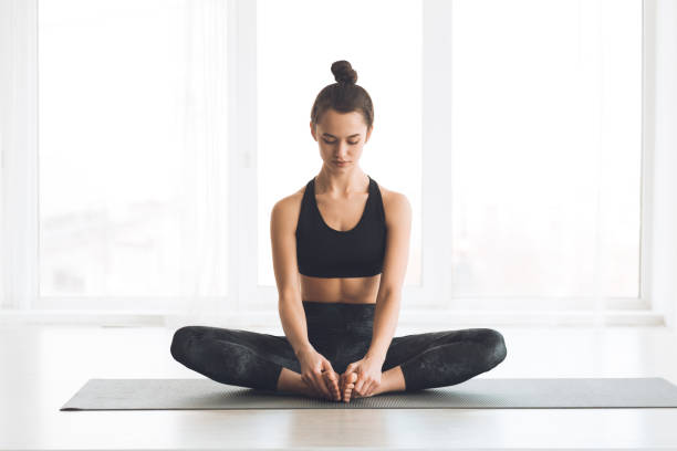 istock Woman sitting in butterfly position with bare feet 1206004806