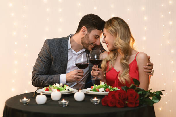 istock Affectionate Couple Clinking Glasses During Romantic Date In Restaurant 1206004940
