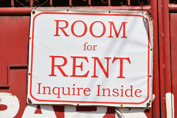istock Signage with offered room for rent hanging outside 1206007909