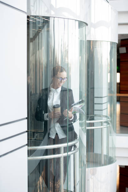 istock Energetic business lady in elevator 1206008469